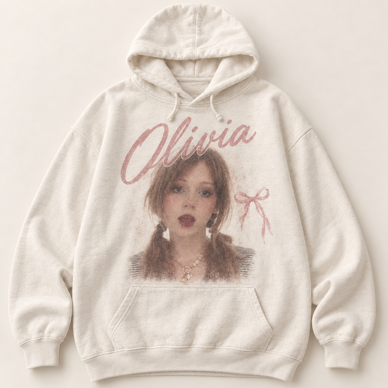 Cream Olivia hoodie with a portrait of a person with pigtails and a rose bow